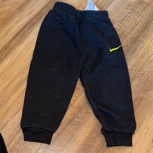 Nike Kids Black Joggers with Yellow Swoosh